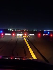 Solar airfield lights marking closed runway section at Dublin Airport with barrier system for aircraft safety