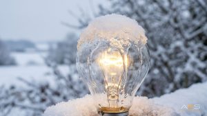 Comparison of heated airfield light lens clear of snow next to unheated lens covered in ice