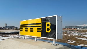 black and yellow taxiway sign